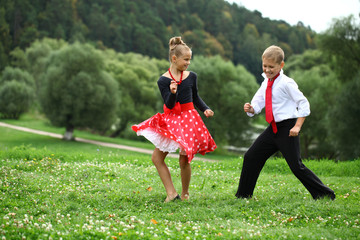 Childrens ballroom dance couple in suits