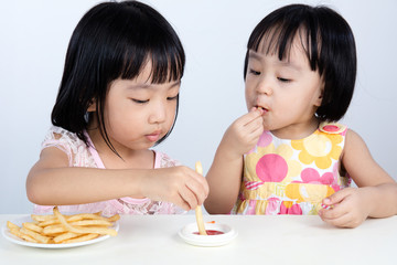 Asian Chinese little girl Eating French fries