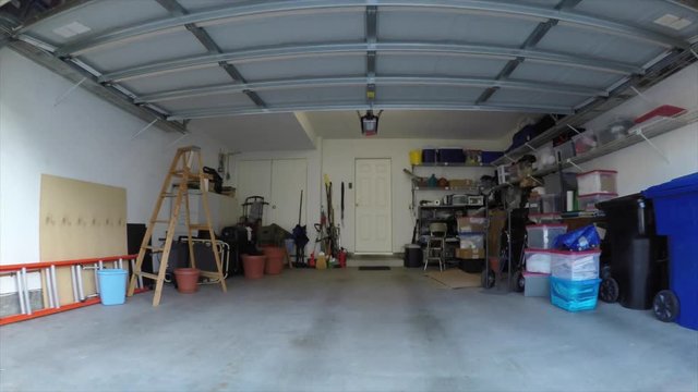 Driving into messy suburban garage car mount shot.  Object brand names and logos were covered.