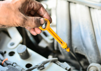 Dirty hands check oil engine ,selective focus, copy space.