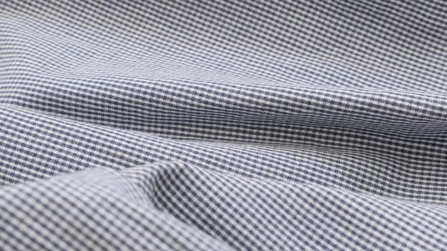 Fine blue and white fabric check pattern for clothing close-up slow tilt 4K 2160p 30fps UHD footage - Chequered material details shallow DOF 4K 3840X2160 UltraHD tilting video 