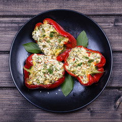 Stuffed red peppers in black plate