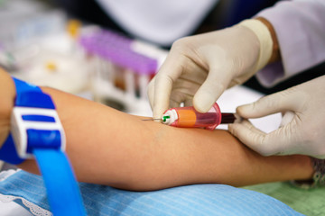 Laboratory with nurse taking a blood sample from patient