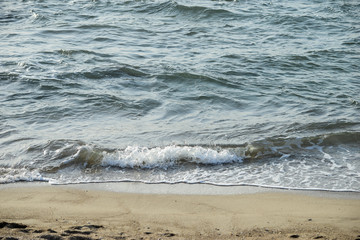 Wave is covering a sea beach sand