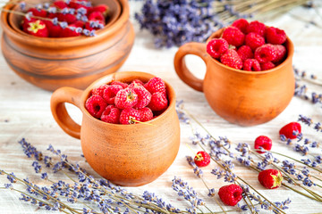 pottery with strawberries and lavender on wooden table