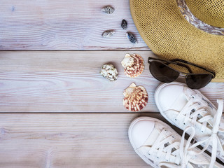 Beach accessories on wooden background. Holidays concept. View from above