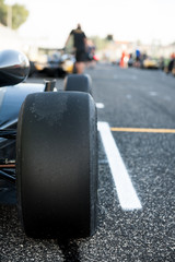 Black slick motor sport car tire close up