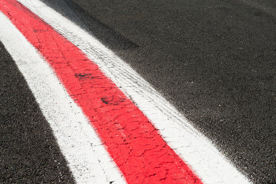 Turning red and white lines on dark grey asphalt