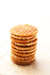 Close up of stack of Dutch caramel waffles on a waxed paper.