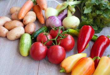 Close up of various colorful fresh raw vegetables. Flat lay. On black wooden table.