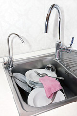 washing dishes in the sink in the kitchen