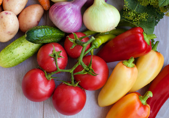 Close up of various colorful fresh raw vegetables. Flat lay. On black wooden table.