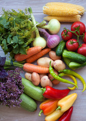 Close up of various colorful fresh raw vegetables. Flat lay. On black wooden table.