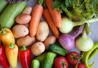 Close up of various colorful fresh raw vegetables. Flat lay. On black wooden table.