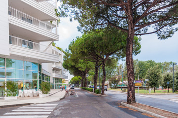 Luxury summer tropic hotel resort villa building exterior street view pine tree restaurant chair nobody