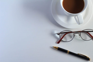 Coffee and glasses and pen