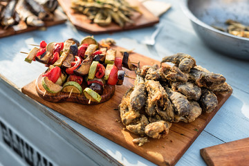Grilled Vegetable Skewers and fish. Street food festival.