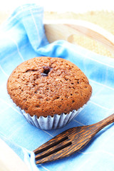 Close up of chocolate cup cake in a wooden tray.