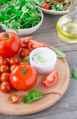Set of different tomatoes on a wooden table