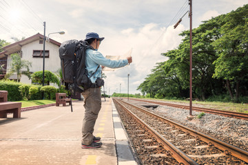 Traveler with backpack at the train station. Travel concept.