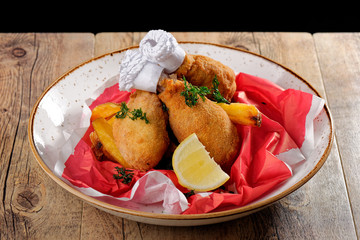 Fried chicken legs with french fries on the table