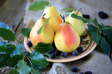 Autumn pears with blackberries on the plate