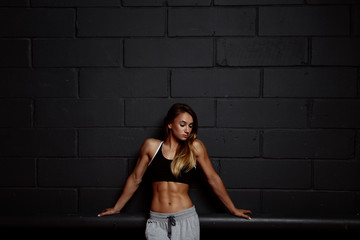 Fototapeta na wymiar Muscular body of a young woman, abs close up. Woman's abs