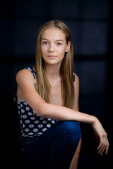 Fototapeta premium Low key portrait of young sensual girl with natural makeup and b