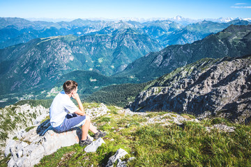 Naklejka na ściany i meble holidays in mountain - boy contemplate the view 