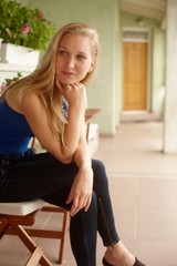 Daydreaming woman sitting on balcony