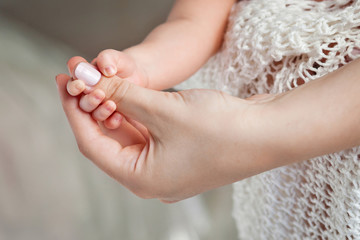 Newborn children's hand in mother hand. Mom and her Child.