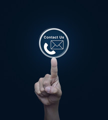 Hand pressing telephone and mail icon button over blue backgroun