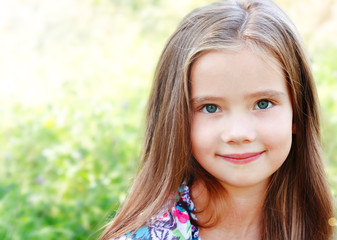 Portrait of adorable smiling little girl in summer day