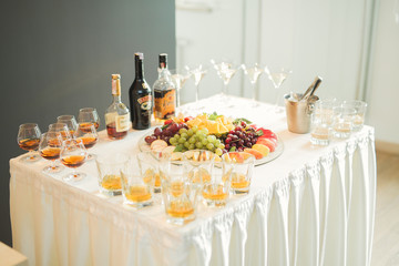 Delicious and tasty dessert table with cupcakes shots at reception closeup