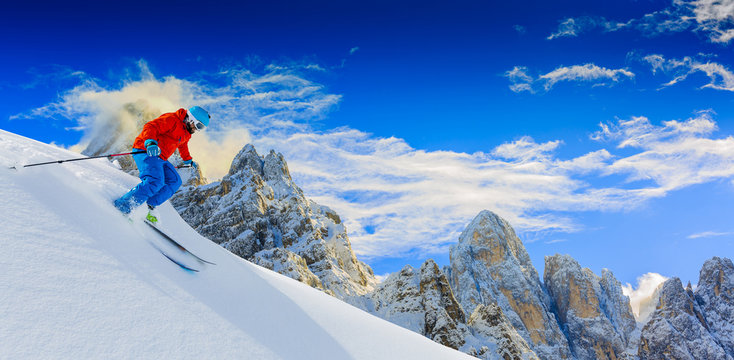 Man skiing in fresh powder snow in Italians Alps.