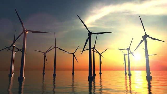 Wind power turbines at sea sunset. 4K dolly clip
