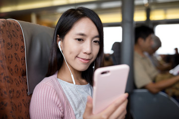 Woman listen to music by mobile phone