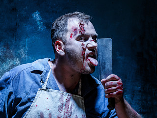 Bloody Halloween theme: crazy killer as butcher with a knife