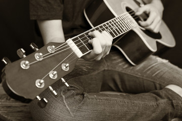 Fototapeta na wymiar Close up of male hands playing guitar