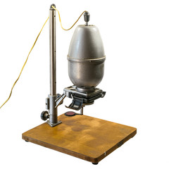 Darkroom equipment - retro photographic enlarger on white background