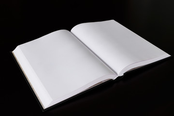 Open book on the dark table.