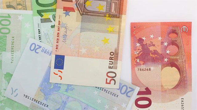 Euro banknotes drop down quickly on a white background. Concept for money, wealth, pay bill and salary.
