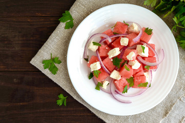Dietary salad from fresh watermelon, blue onion and goat cheese (feta). top view