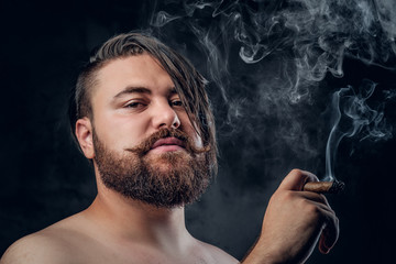 Bearded male smoking a cigarette.
