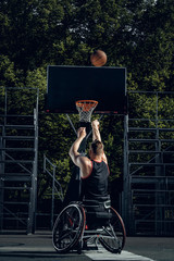 Naklejka premium Cripple basketball player in wheelchair plays basketball.
