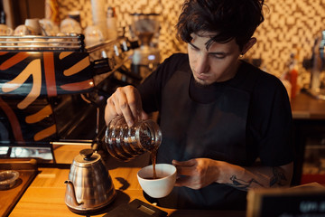 Fototapeta na wymiar Barista at work in a coffee shop