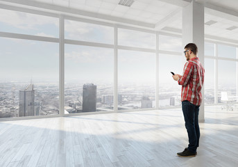 Hipster guy use his smartphone . Mixed media