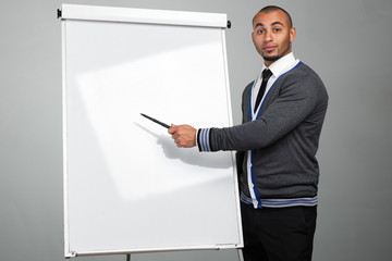 Black male  pointing to  whiteboard