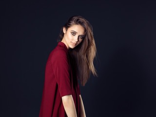 Fototapeta premium Fashion photo of young beautiful woman on black background.