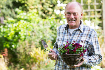 Portrait Of Senior Man Working In Garden